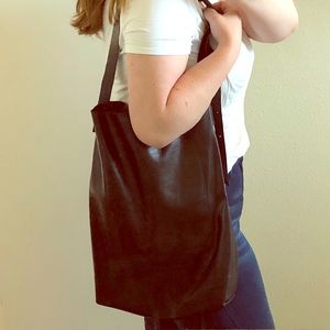 Black leather tote bag with adjustable strap